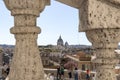 View of Rome with the Basilica of SS. Ambrose and Charles on the Corso through a marble balustrade Royalty Free Stock Photo